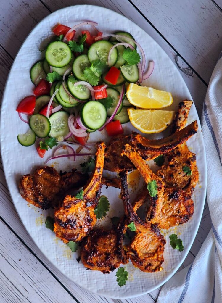 Tandoori Lamb Chops served with salad and lemon slices