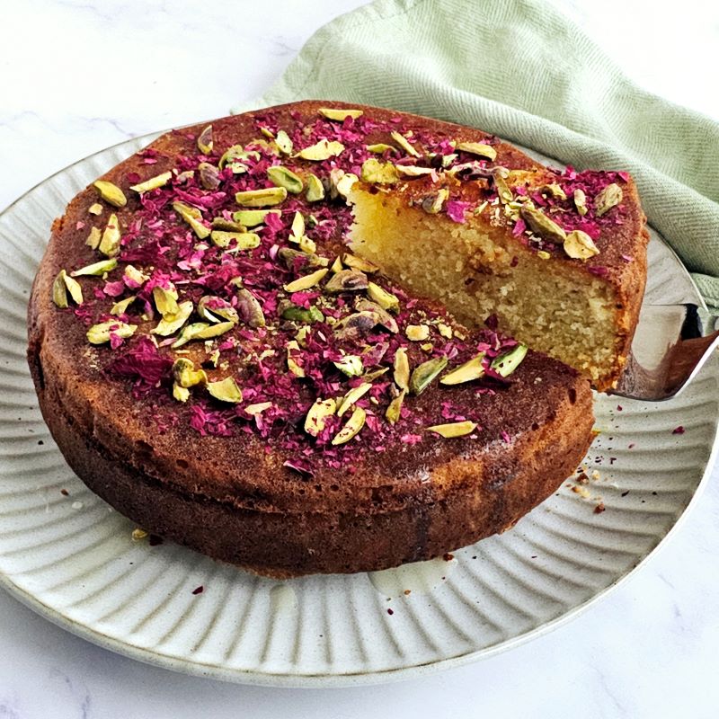 Persian Love Cake with syrup  and rose petals and pistachios on top